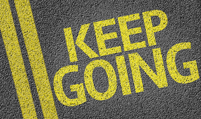 Keep Going written on the road